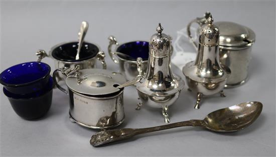 Six assorted silver condiments with three spoons and a silver teaspoon.